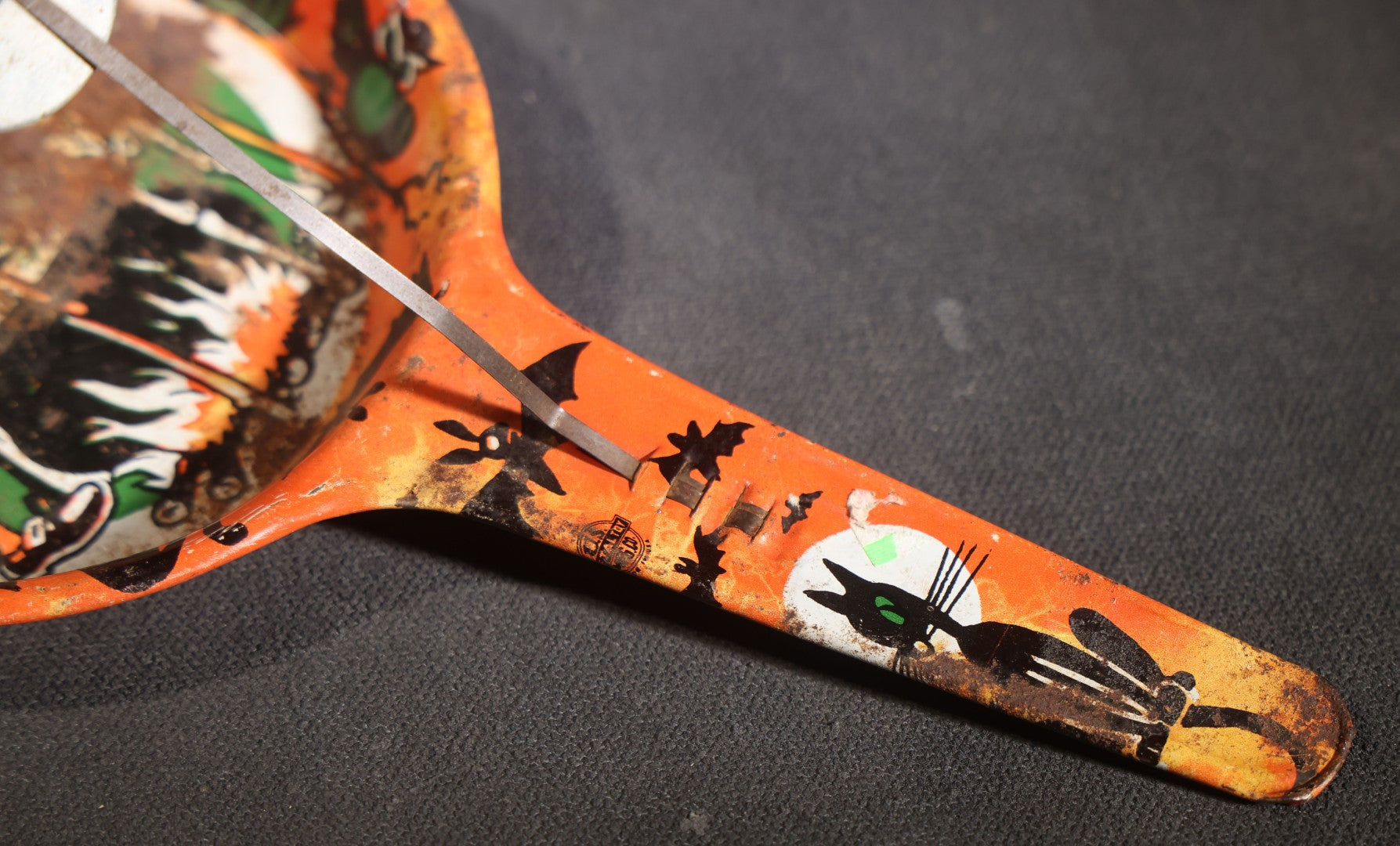 Lot 049 - Pair Of Vintage Halloween Tin Lithograph Paddle Noisemakers, T. Cohn Inc. Jack-O-Lantern J.O.L. And Witch Woman, And U.S. Metal Toy Mfg. Co. Witch, Ghost, Black Cat, And Haunted House