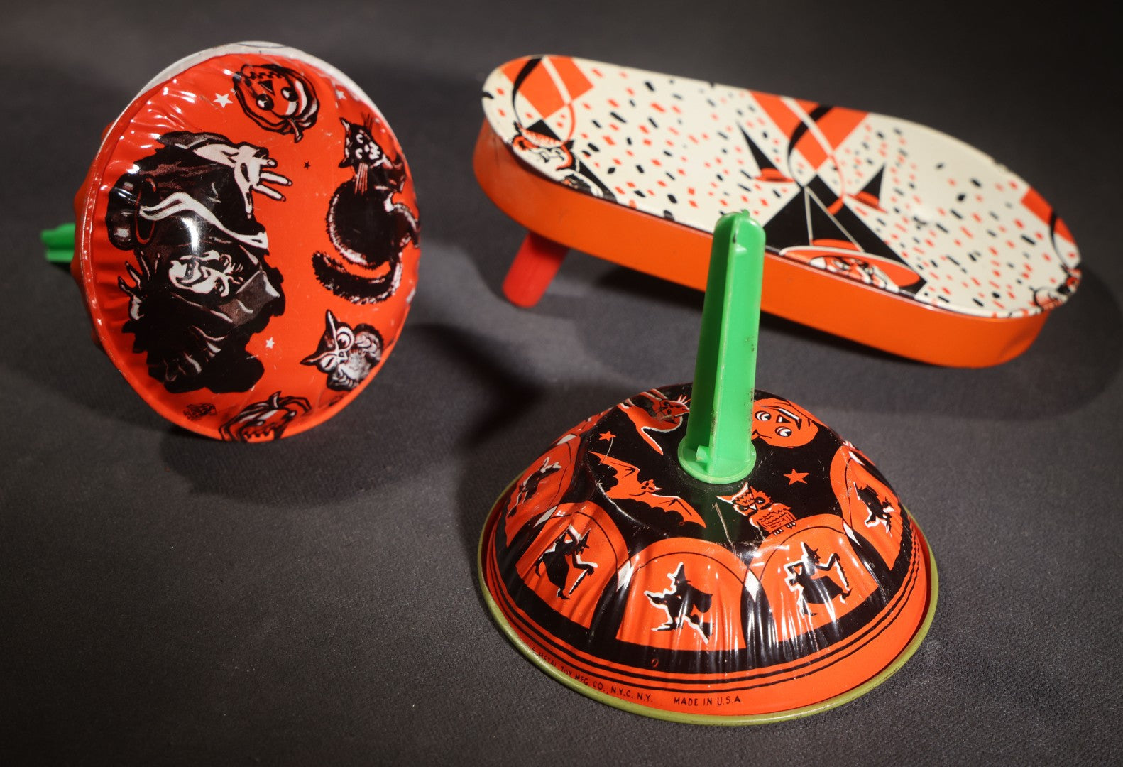 Lot 050 - Trio Of Vintage Halloween Tin Lithograph Noisemakers, U.S. Metal Toy Mfg. Co., With Witch, Bat, Jack-O-Lantern, And Cat Graphics, Bell Rattle, And Clapper Examples
