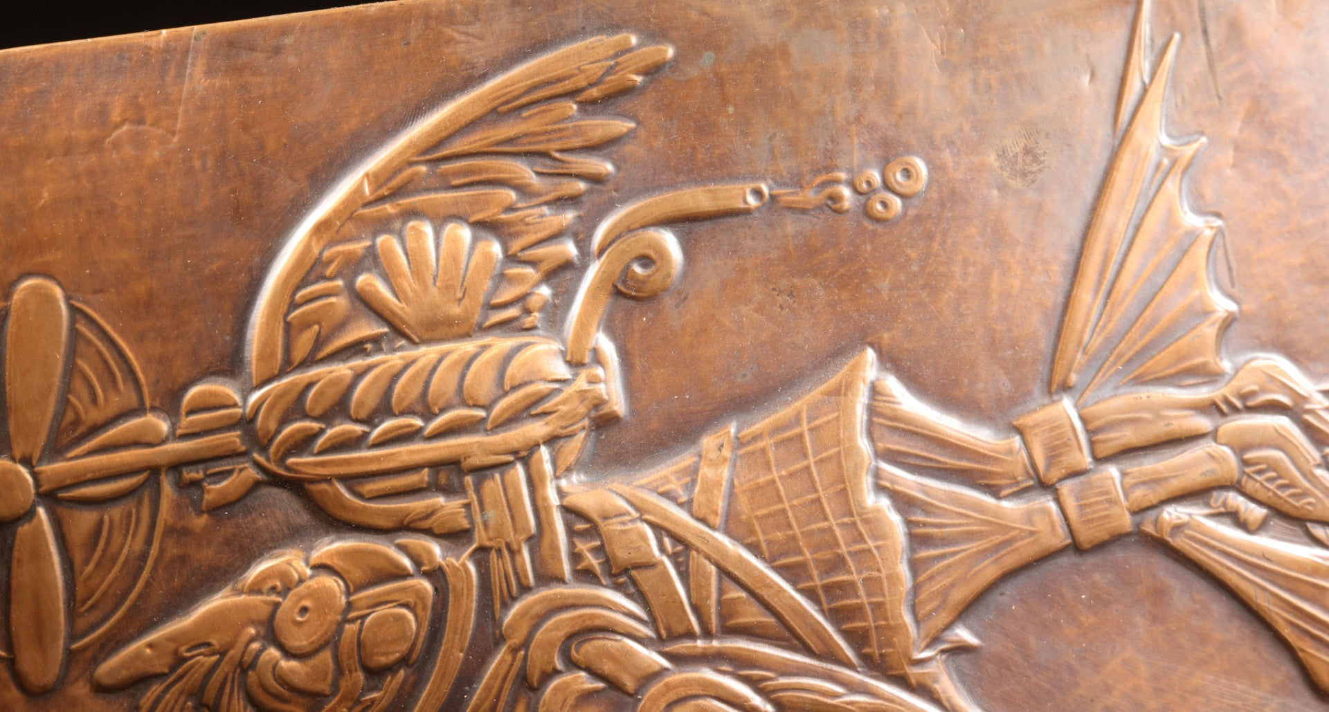 Lot 051 - Vintage Copper Repoussé Plaque On Plywood, Fantastical Winged Figure On Unicycle With Propeller, Signed And Dated 1969, Gifted From Reck, Germany, 1972, 9-1/4" x 13"