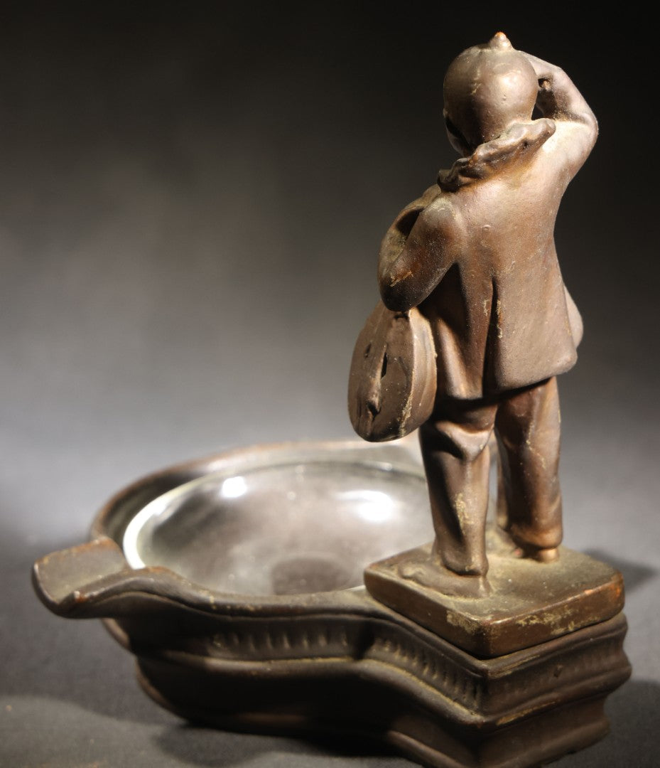 Lot 052 - Antique Copper-Clad Composition Figural Ashtray, Standing Pierrot Clown Holding A Lute, Glass Tray Insert, 6-5/8" H