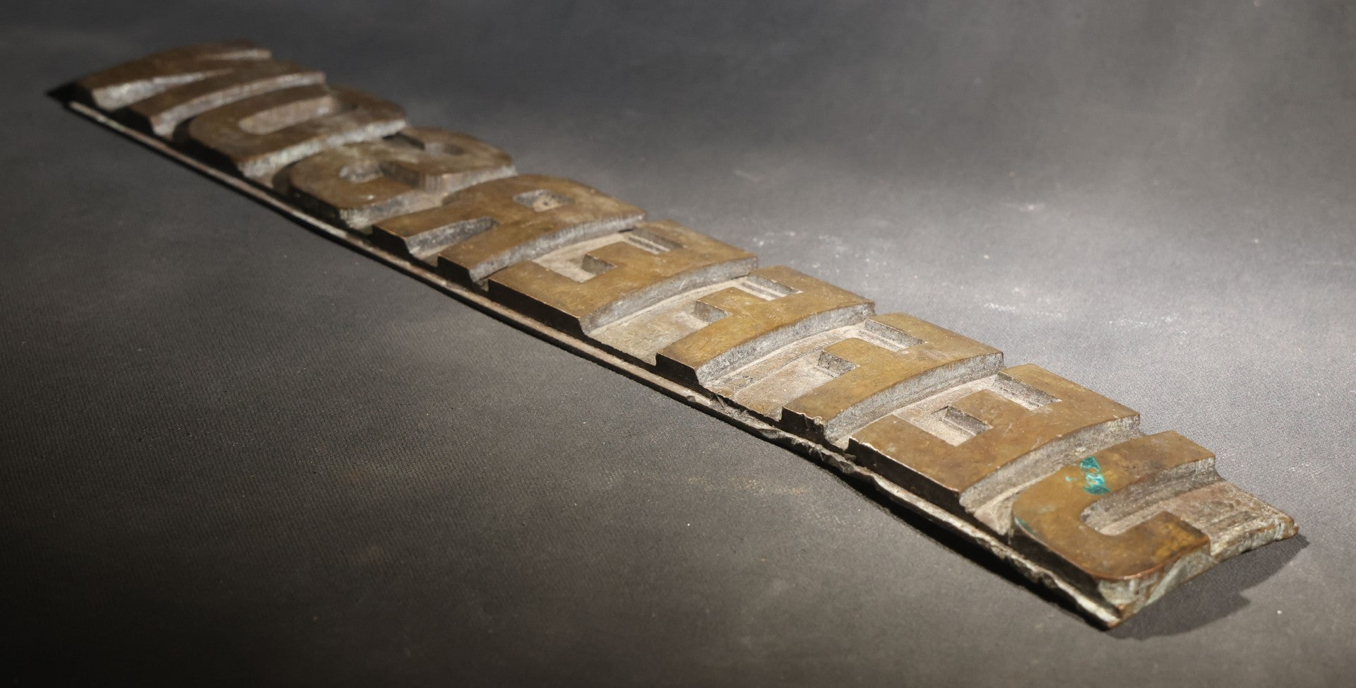 Lot 057 - Antique Bronze Printing Plate, "Jefferson" In Relief Block Letters, Milled Surface, Bowed, 16-1/4" L