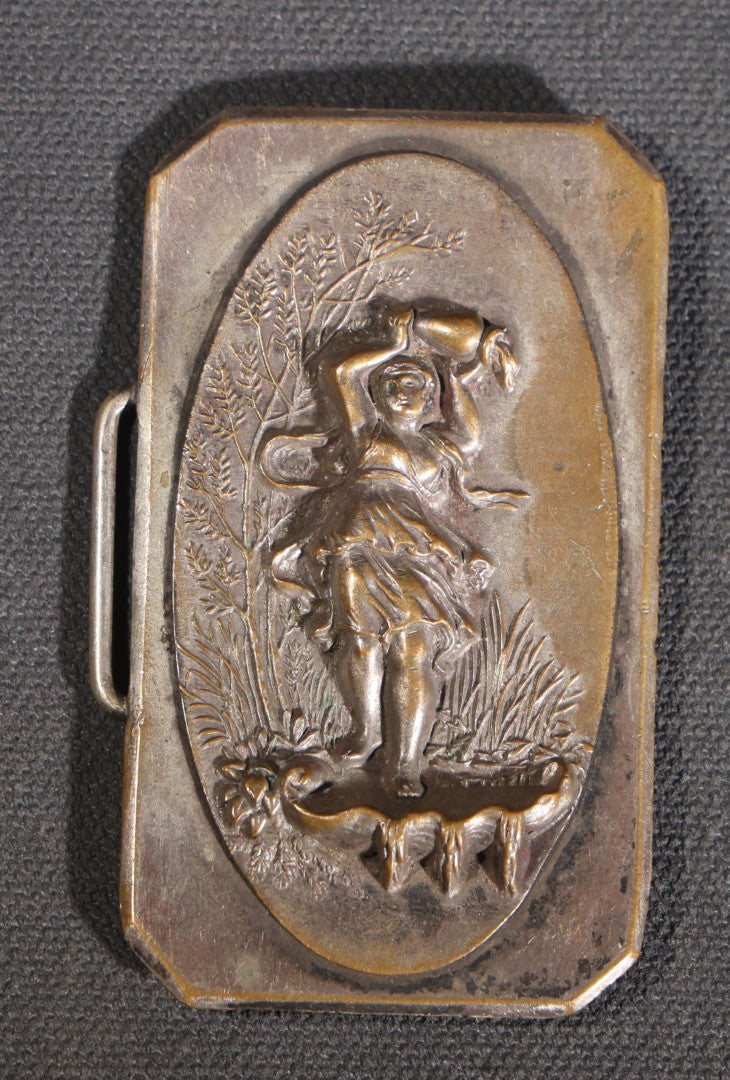 Lot 081 - Antique Silver-Plated Two-Piece Belt Buckle With Embossed Figural Woman Carrying Water Jug In Garden Setting