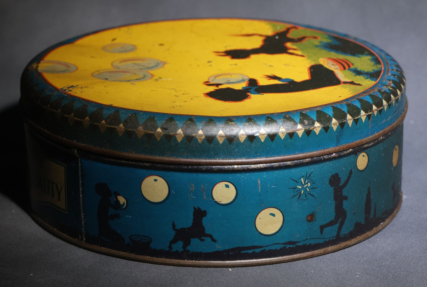Lot 085 - Antique Maynards "Stands For Quality" Tin Lithograph Candy Tin With Silhouette Graphics Of Child Blowing Bubbles With Dog
