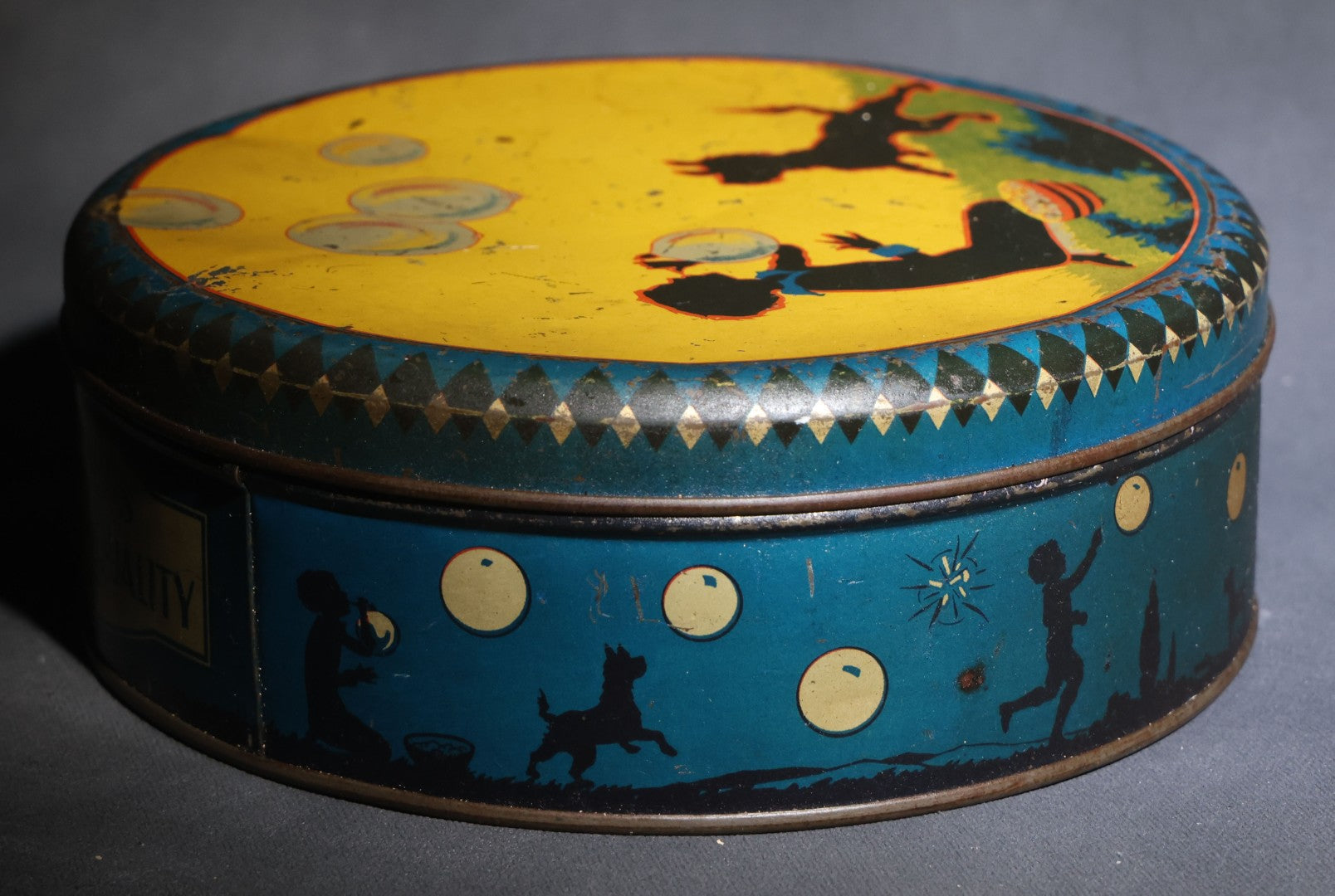 Lot 085 - Antique Maynards "Stands For Quality" Tin Lithograph Candy Tin With Silhouette Graphics Of Child Blowing Bubbles With Dog
