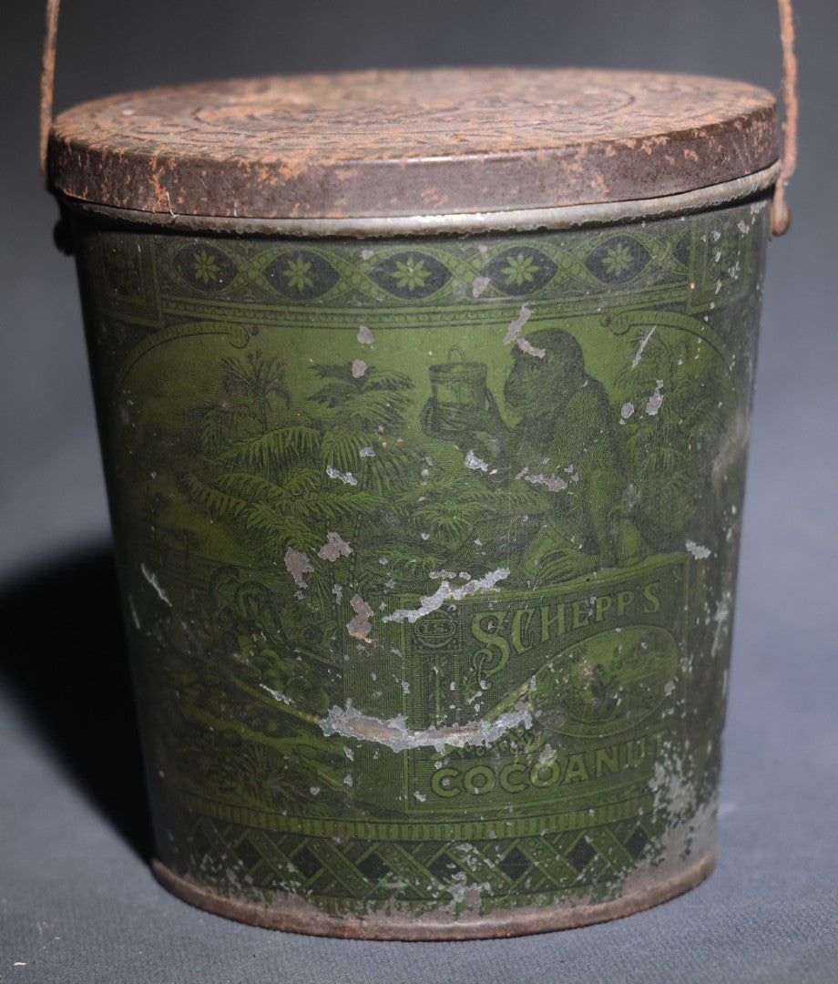 Lot 086 - Antique Schepp's Cocoanut Lithographed Tin Pail With Embossed Lid, Tropical Scene With Monkey, Palm Trees, And Sailing Ship, Note Graphic Loss