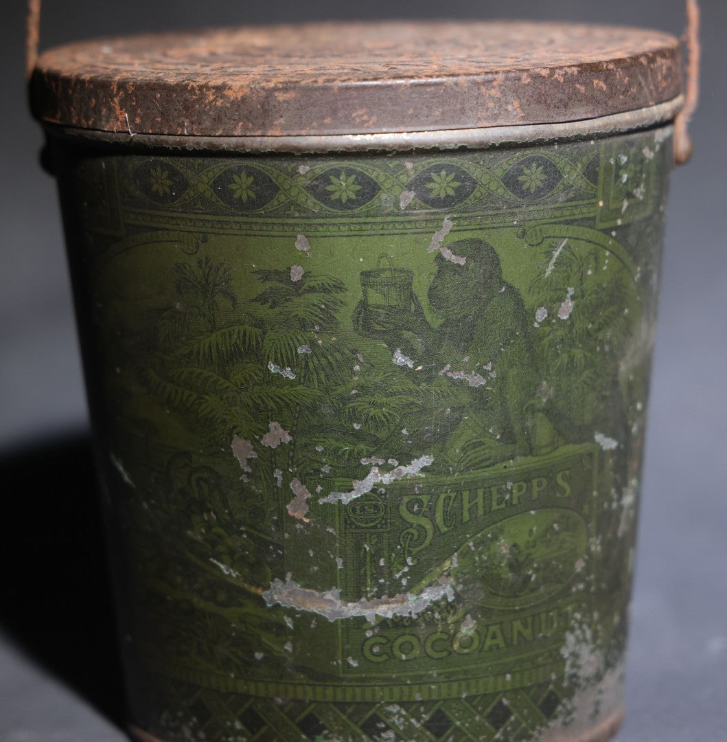 Lot 086 - Antique Schepp's Cocoanut Lithographed Tin Pail With Embossed Lid, Tropical Scene With Monkey, Palm Trees, And Sailing Ship, Note Graphic Loss