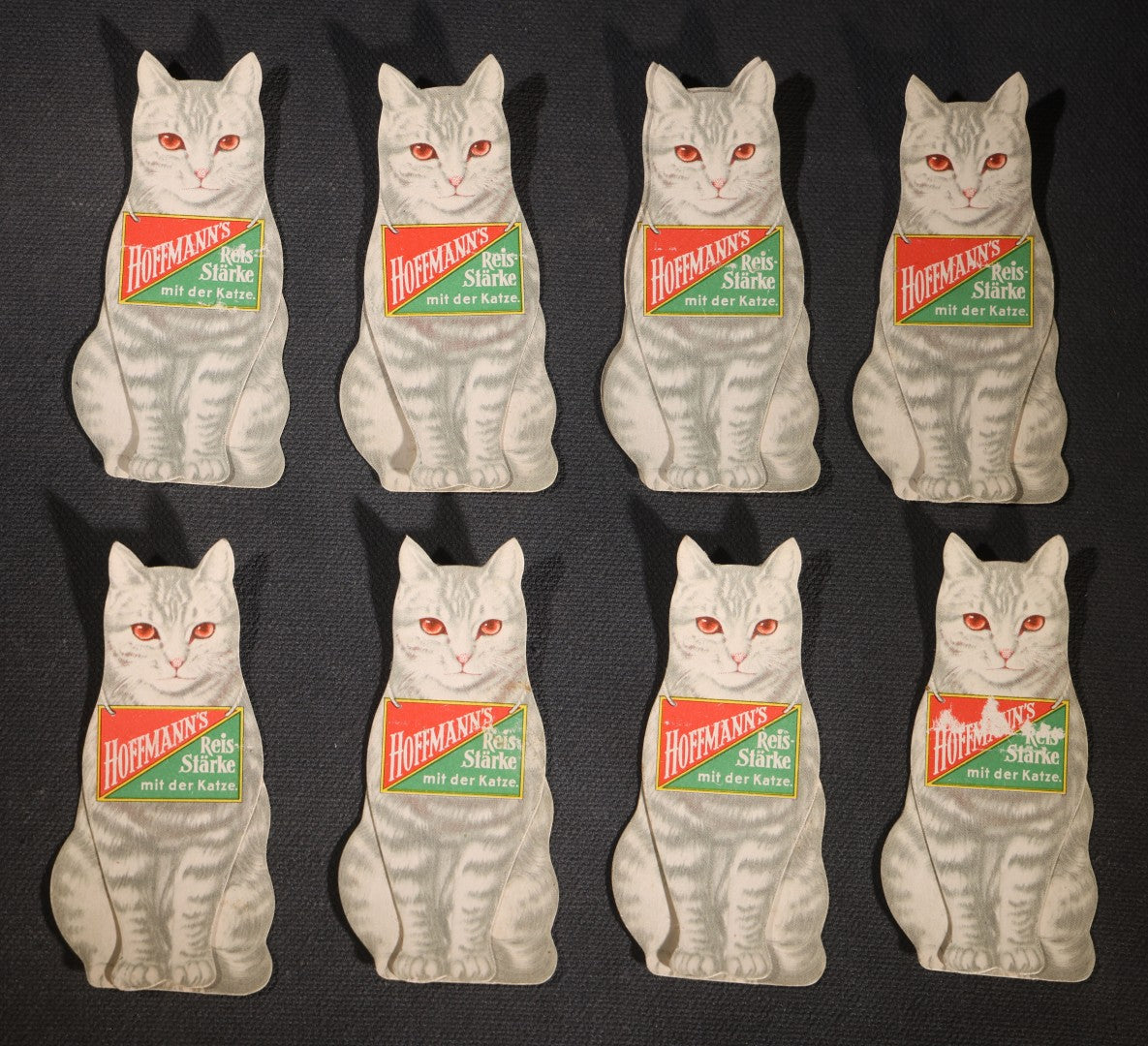 Lot 089 - Grouping Of Eight Antique Hoffmann's Reis-Starke Die-Cut Cat-Shaped Folding Paper Advertisements, "Hoffmann's Reis-Starke Mit Der Katze" ("Hoffmann's Rice Starch With The Cat")