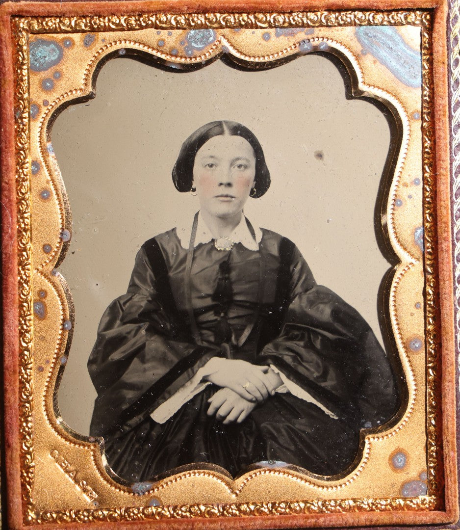 Lot 117 - Antique 1/6th Plate Ruby Ambrotype Photograph, Full Intact Leatherette Union Case, Young Woman In Dark Dress With Crossed Hands, Embossed Thistle And Floral Case Design