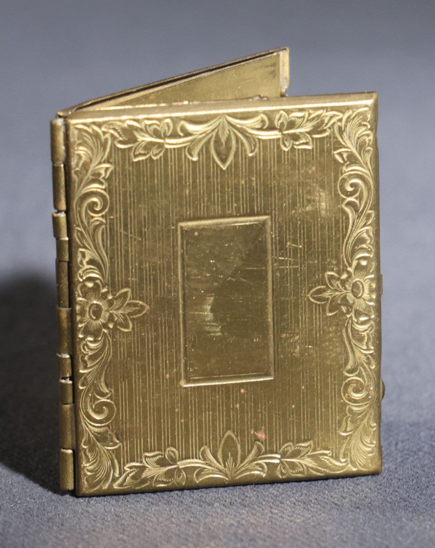 Lot 119 - Antique Tintype Photograph In Brass Book-Form Locket Case, Elderly Woman In Dark Dress, Engraved Floral And Scroll Design