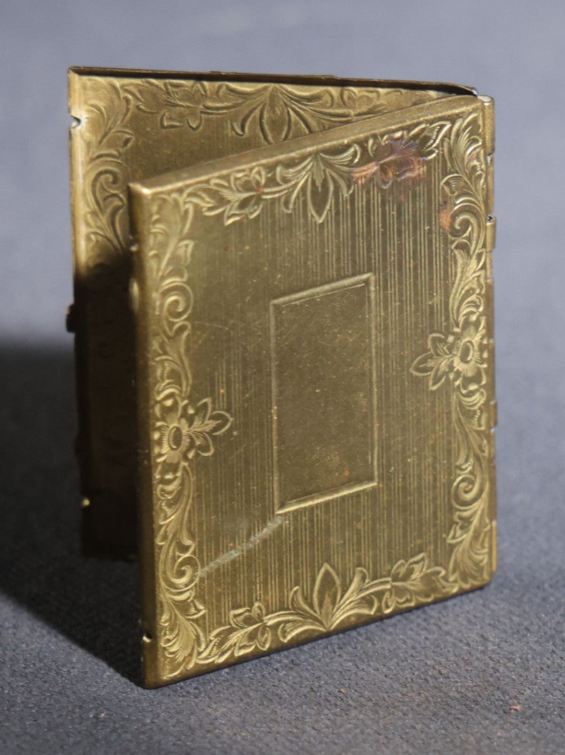 Lot 119 - Antique Tintype Photograph In Brass Book-Form Locket Case, Elderly Woman In Dark Dress, Engraved Floral And Scroll Design