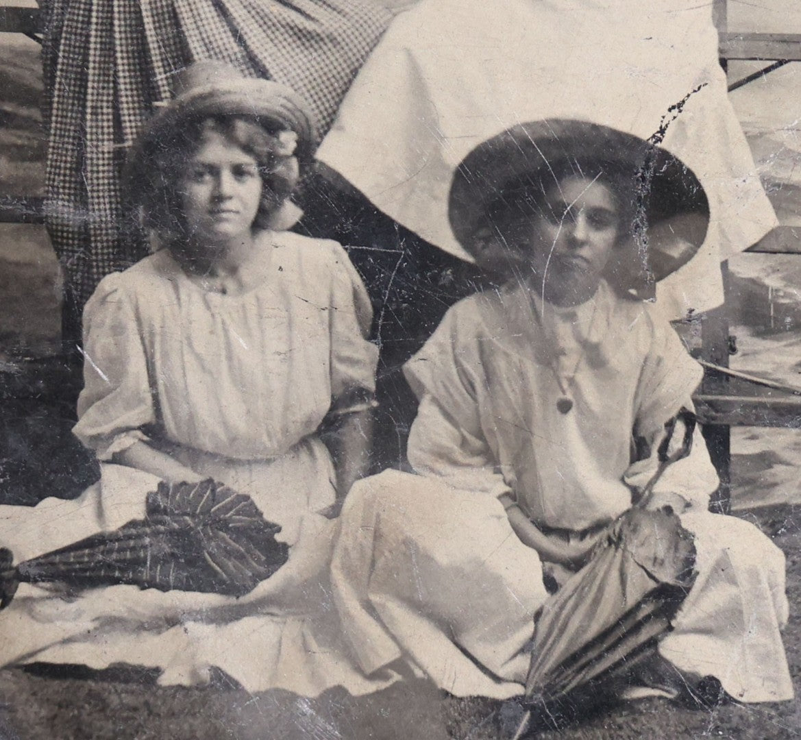 Lot 120 - Antique Tintype Photograph Of Five Young Women In Wide-Brimmed Hats With Parasols, Man Peeking Through Hole In Studio Backdrop, Seaside Scene