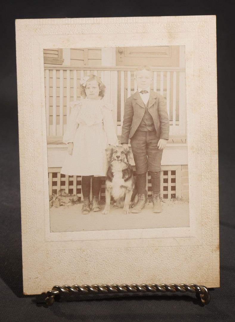 Lot 129 - Pair Of Antique Cabinet Card Photographs With Dogs, Young Woman With Black And White Dog Beside A Clapboard House And Two Children With A Collie On A Porch