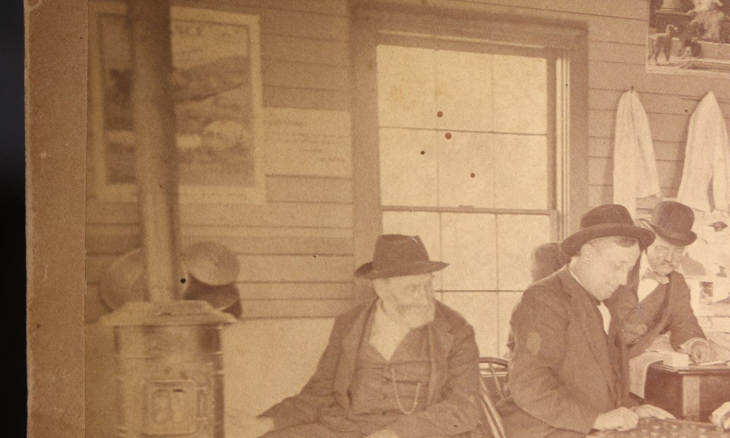 Lot 130 - Antique Boudoir-Size Cabinet Card Photograph Of Three Men Playing Checkers In A Store Interior With Pot-Belly Stove, Calendars, And Rocking Chair, Pencil-Inscribed "Uncle Ed"