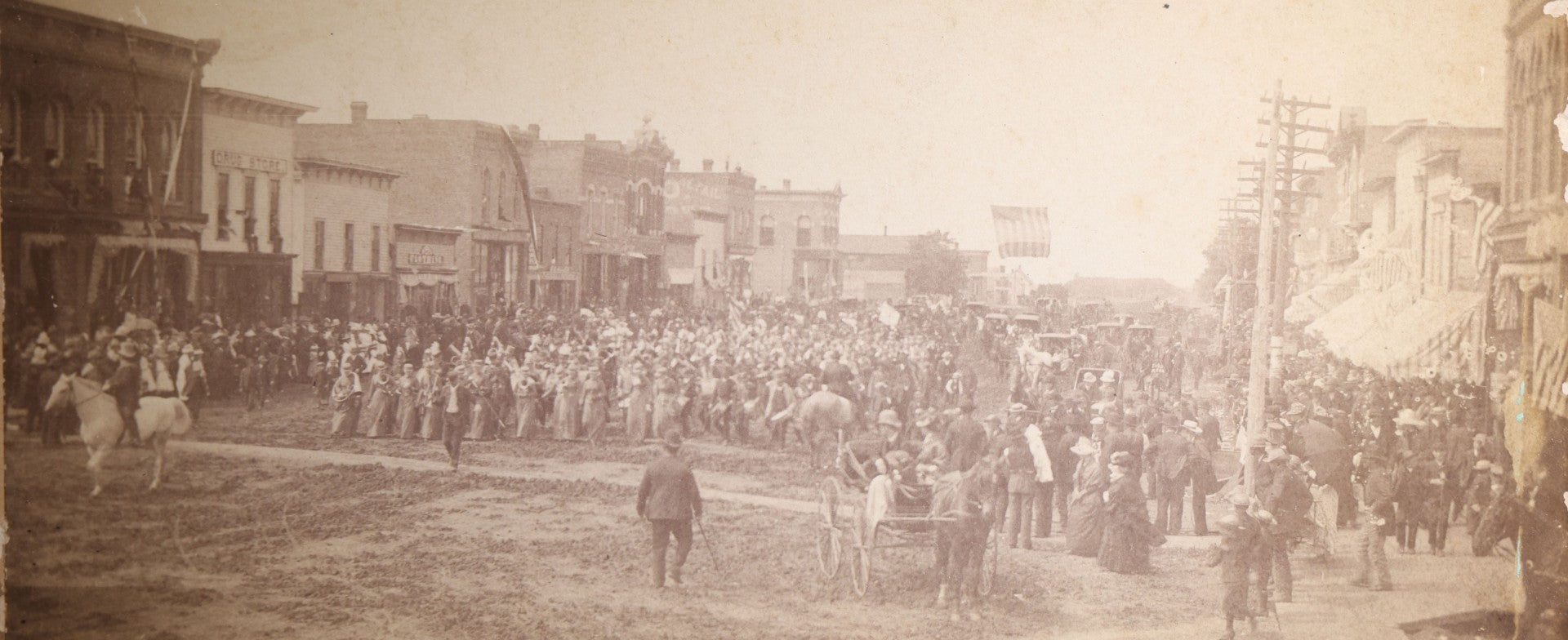Lot 131 - Antique Board-Mounted Panoramic Photograph Of A Parade On Main Street, Storm Lake, Iowa, Photographed By Coman, Crowds, Horseback Rider, And American Flag