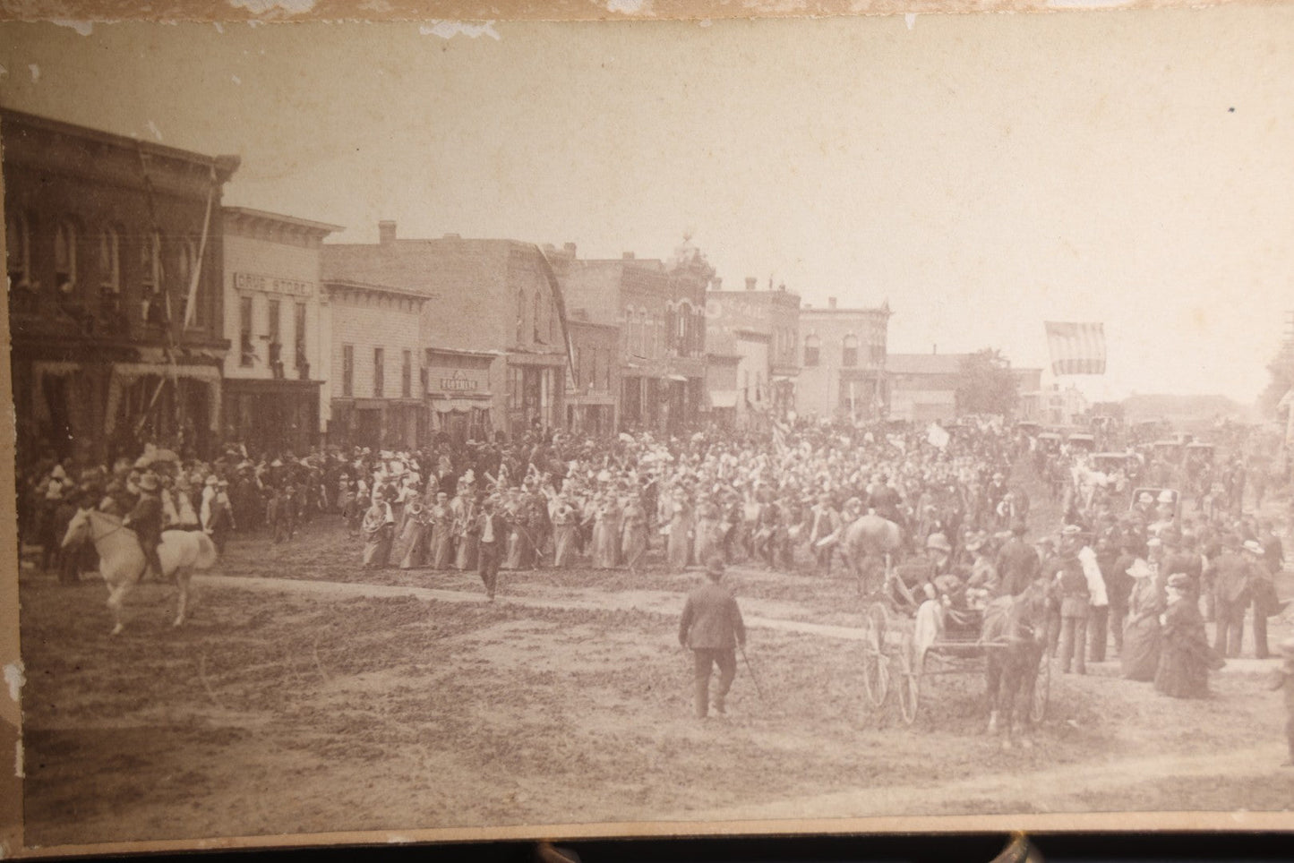Lot 131 - Antique Board-Mounted Panoramic Photograph Of A Parade On Main Street, Storm Lake, Iowa, Photographed By Coman, Crowds, Horseback Rider, And American Flag