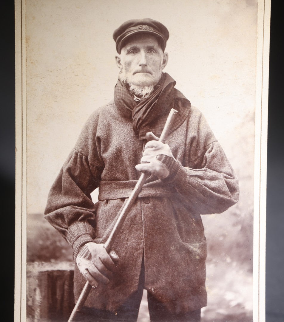 Lot 134 - Antique Cabinet Card Photograph Of A Rugged New England Man In Heavy Coat, Cap, Gloves, And Scarf Holding A Walking Stick, Ink-Inscribed "Joel Simons," Photographed By Bullock, Northfield, Vermont