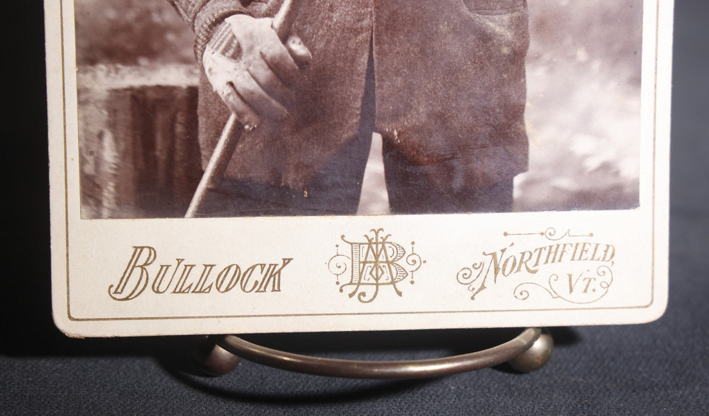 Lot 134 - Antique Cabinet Card Photograph Of A Rugged New England Man In Heavy Coat, Cap, Gloves, And Scarf Holding A Walking Stick, Ink-Inscribed "Joel Simons," Photographed By Bullock, Northfield, Vermont