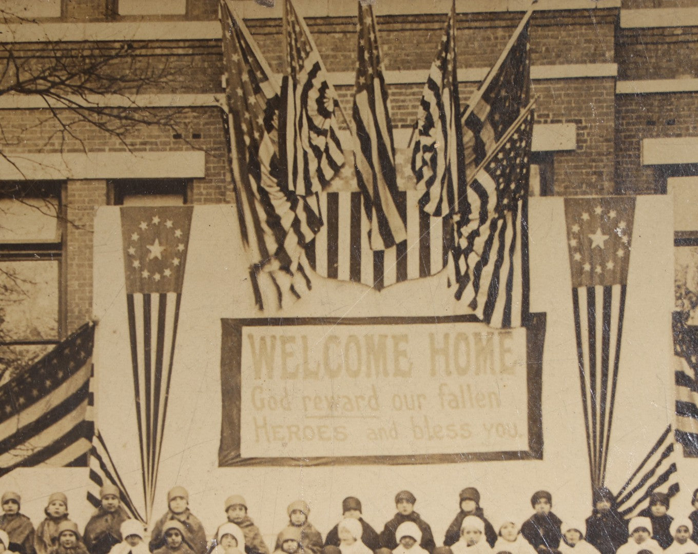 Lot 138 - Antique Board-Mounted Photograph Of Children Posed On Steps Of A Brick Building With WWI "Welcome Home" Banner, American Flags, And Patriotic Bunting, Photographed By Shea's Art Studio, Danbury, Connecticut