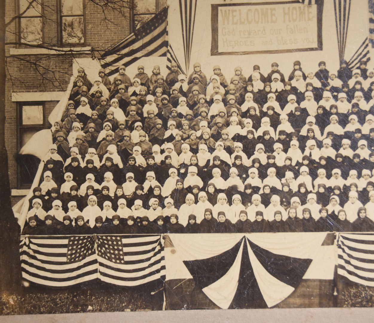 Lot 138 - Antique Board-Mounted Photograph Of Children Posed On Steps Of A Brick Building With WWI "Welcome Home" Banner, American Flags, And Patriotic Bunting, Photographed By Shea's Art Studio, Danbury, Connecticut