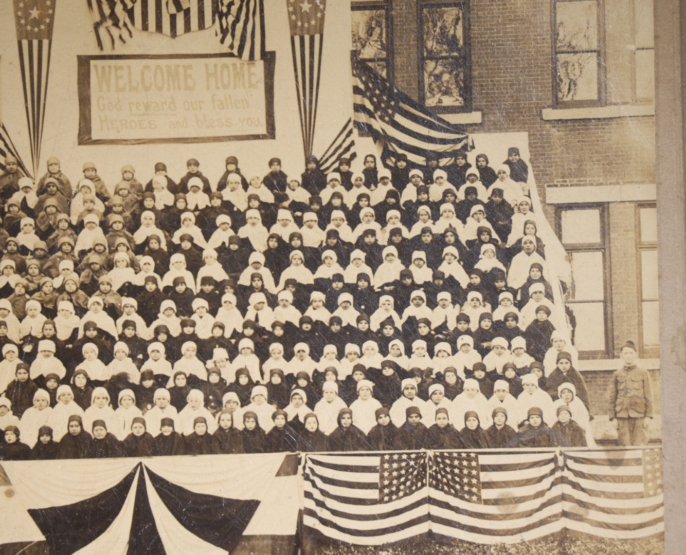 Lot 138 - Antique Board-Mounted Photograph Of Children Posed On Steps Of A Brick Building With WWI "Welcome Home" Banner, American Flags, And Patriotic Bunting, Photographed By Shea's Art Studio, Danbury, Connecticut