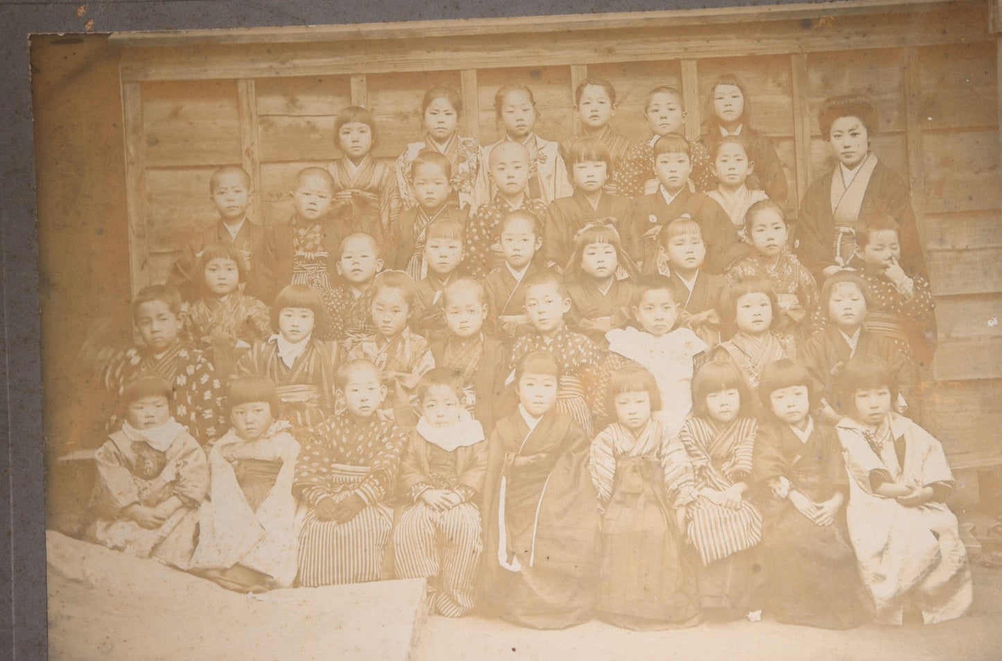 Lot 139 - Antique Board-Mounted Photograph Of Japanese Children In Kimono With Their Teacher, One Child Picking His Nose, Photographed By N. Ohashi
