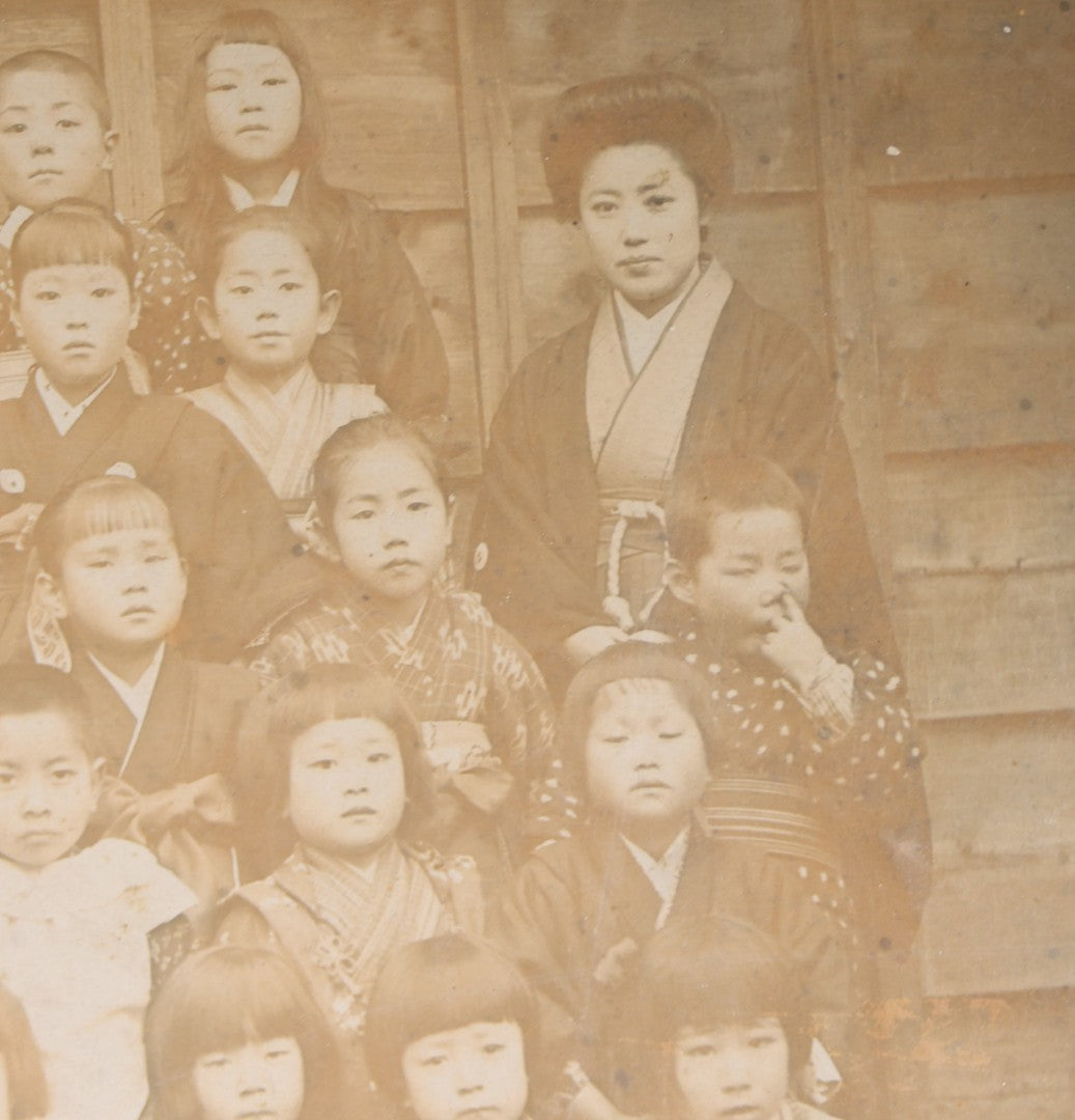 Lot 139 - Antique Board-Mounted Photograph Of Japanese Children In Kimono With Their Teacher, One Child Picking His Nose, Photographed By N. Ohashi