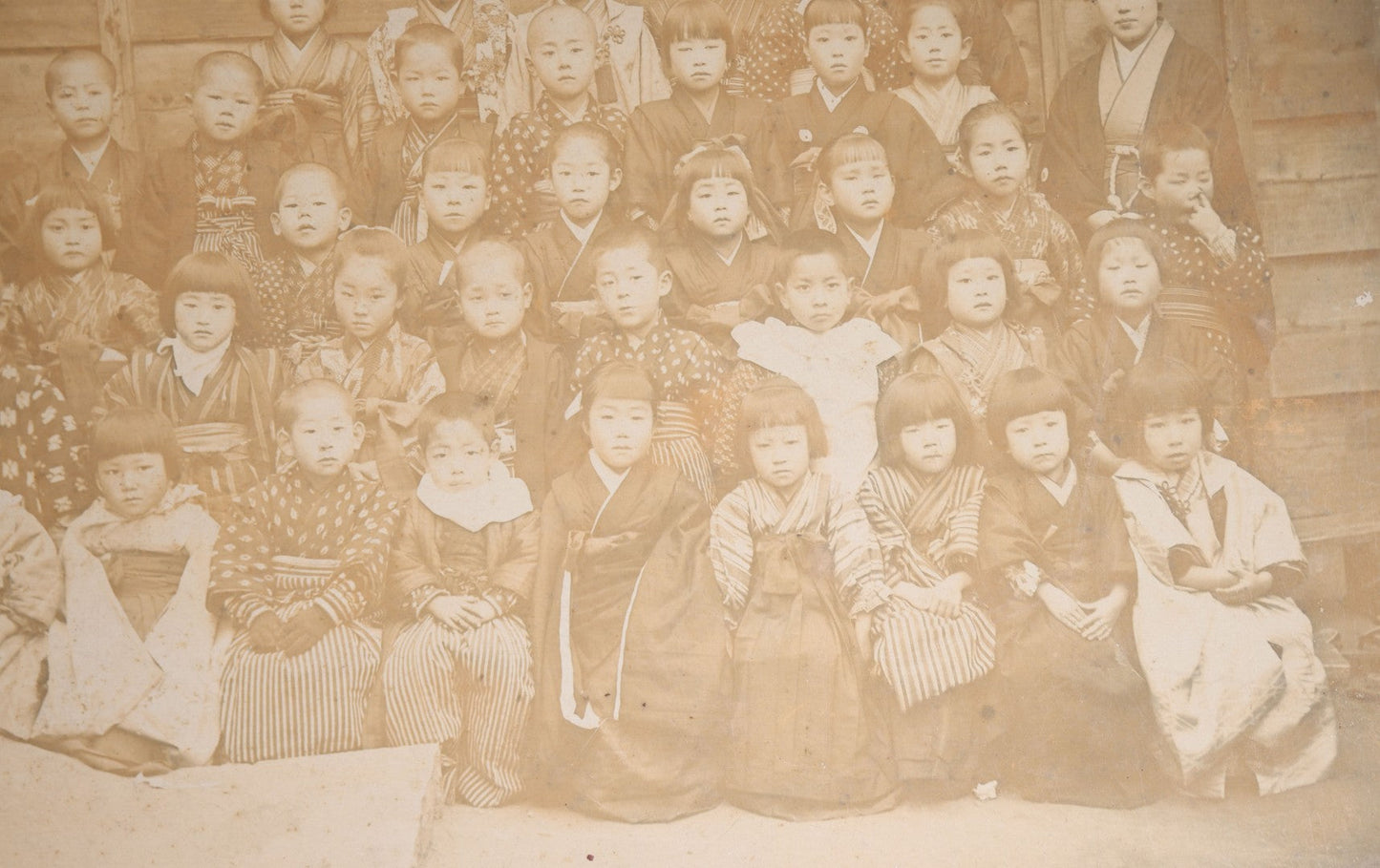 Lot 139 - Antique Board-Mounted Photograph Of Japanese Children In Kimono With Their Teacher, One Child Picking His Nose, Photographed By N. Ohashi