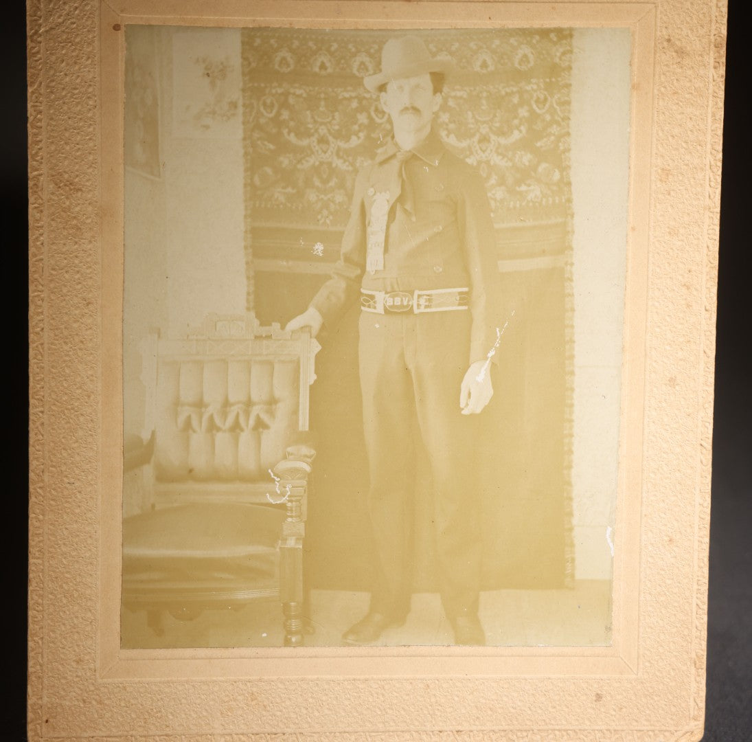 Lot 143 - Antique Board-Mounted Photograph Of A Man In Western Dress With Cowboy Hat, Decorative Shirt, And Fraternal Ribbon Badge With Eagle Device, "Bbv" Belt Buckle