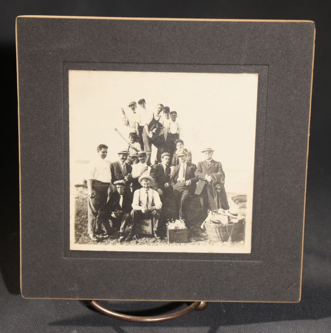 Lot 144 - Grouping Of Seven Antique Board-Mounted Photographs Of Outdoor Group Gatherings, Including Large Hillside Assembly, Men's Outing With Bottles And Basket, And Men In Aprons