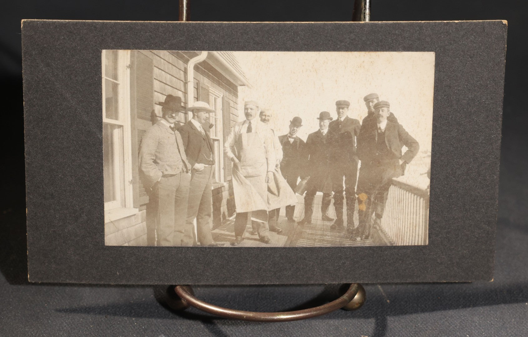 Lot 144 - Grouping Of Seven Antique Board-Mounted Photographs Of Outdoor Group Gatherings, Including Large Hillside Assembly, Men's Outing With Bottles And Basket, And Men In Aprons