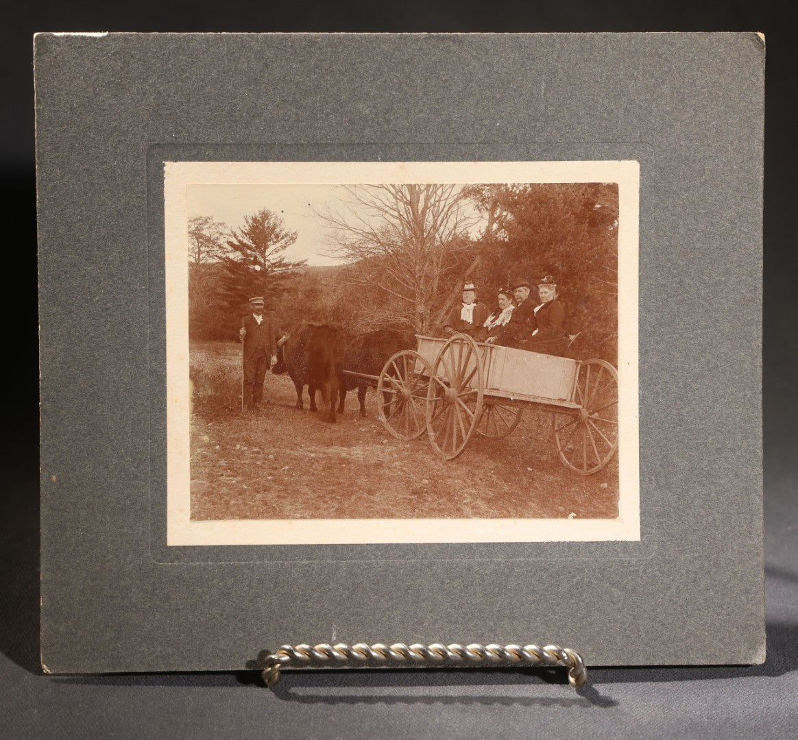 Lot 146 - Trio Of Antique Board-Mounted Photographs Of Ox-Drawn Wagons With Passengers In Rural Settings, Pencil Inscriptions On Verso