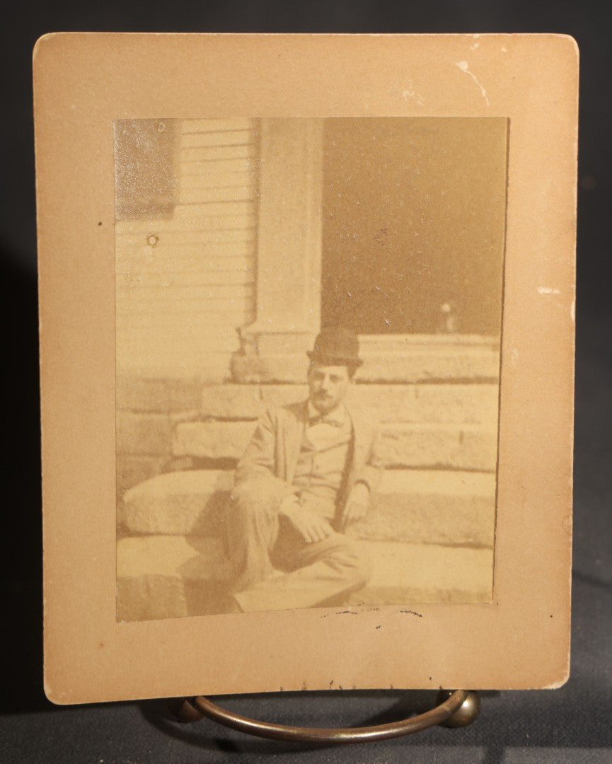 Lot 150 - Grouping Of Six Antique Board-Mounted Photographs Of Men In Social And Leisure Settings, Including Early Automobile Group, City Street Scene With Jackson Sign, Men In Hammock On Porch, And Outdoor Picnic Party