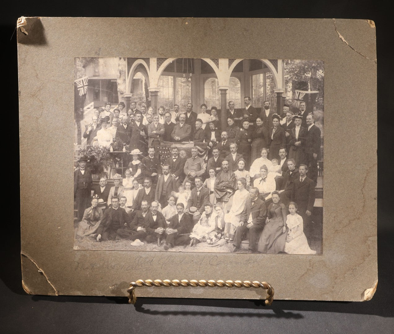 Lot 151 - Trio Of Antique Board-Mounted Group Photographs Including Large Gathering With American And British Flags At Arched Pavilion, Elderly Men In Formal Dress, And Generational Family Studio Portrait