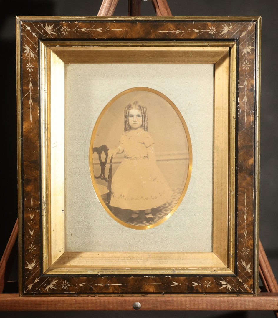 Antique Photograph of a Young Girl in a White Dress, Matted with Oval Gilt Opening, in Ebonized Inlaid Frame