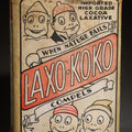 Lot 051 - Vintage Laxo-Koko Imported High Grade Cocoa Laxative Tin, 7 Oz., with Comic Character Graphics, Laxo Products Co., New York, 4-3/4" H