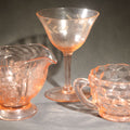 Lot 078 - Trio of Vintage Pink Depression Glass Including Floral Relief Creamer, Cubist Open Sugar, and Etched Champagne Coupe, 5-1/8" H