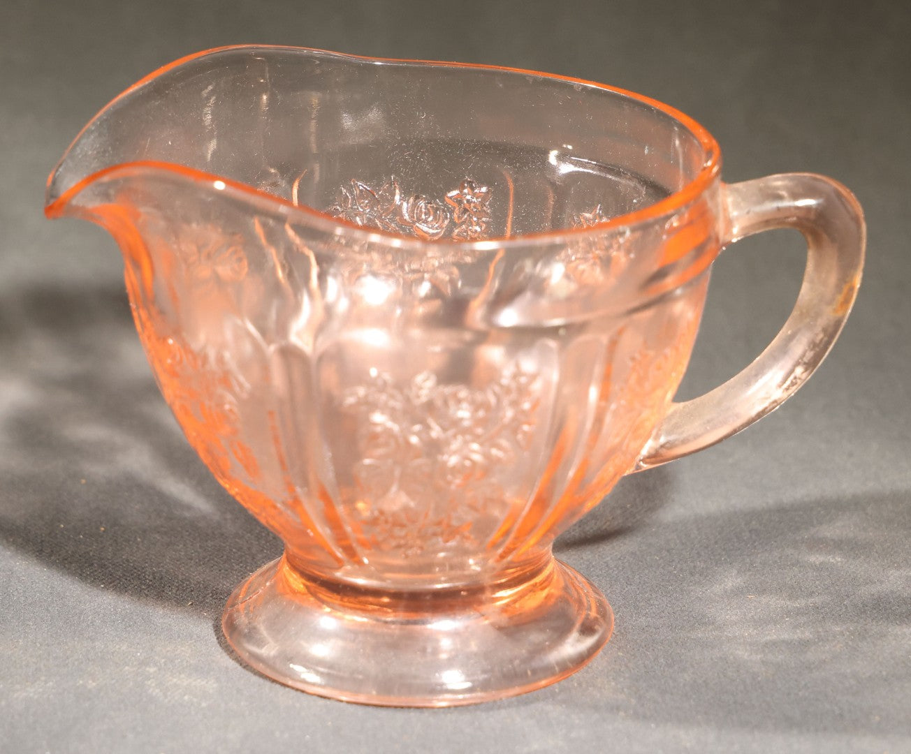 Trio of Vintage Pink Depression Glass Including Floral Relief Creamer, Cubist Open Sugar, and Etched Champagne Coupe