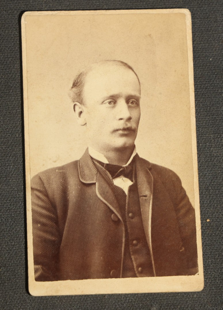 Grouping of 10 Antique Carte De Visite C.D.V. Photographs, Portrait Studies of Men, Women, and Children, Including Two Illustrated Filler Cards