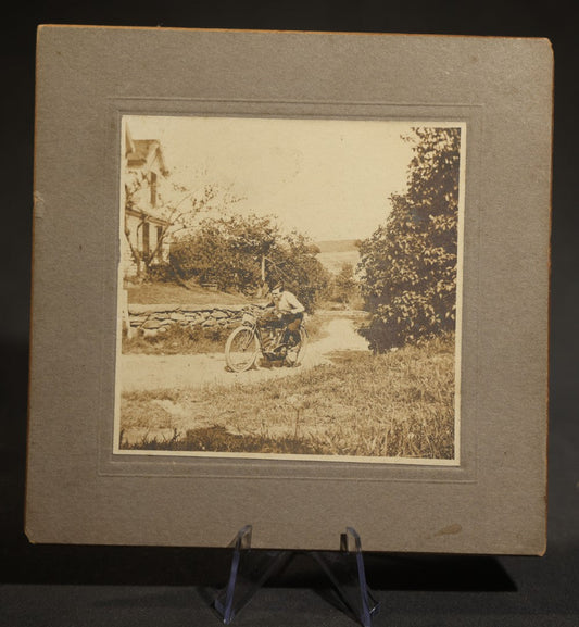 Antique Board-Mounted Photograph of a Young Man Astride an Early Indian Motorcycle on a Rural Road