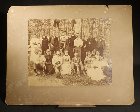 Antique Board-Mounted Photograph of a Large Group Gathered Outdoors in a Wooded Setting, Men and Women in Victorian Dress