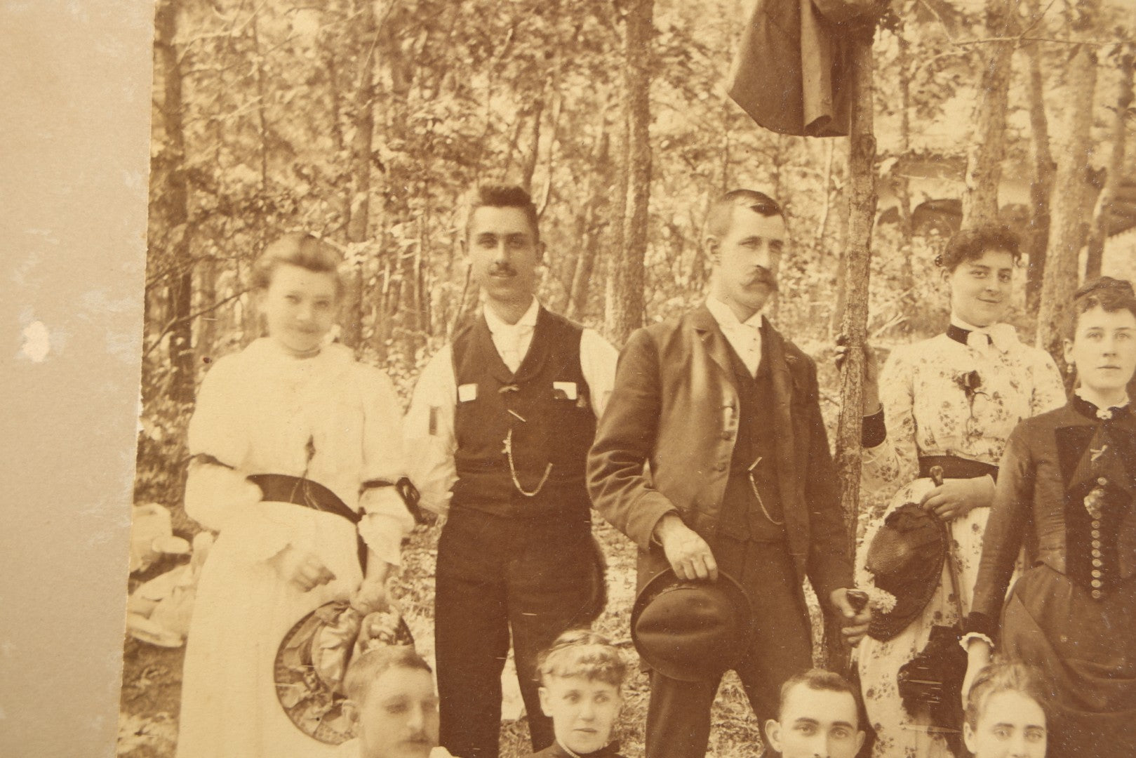 Antique Board-Mounted Photograph of a Large Group Gathered Outdoors in a Wooded Setting, Men and Women in Victorian Dress
