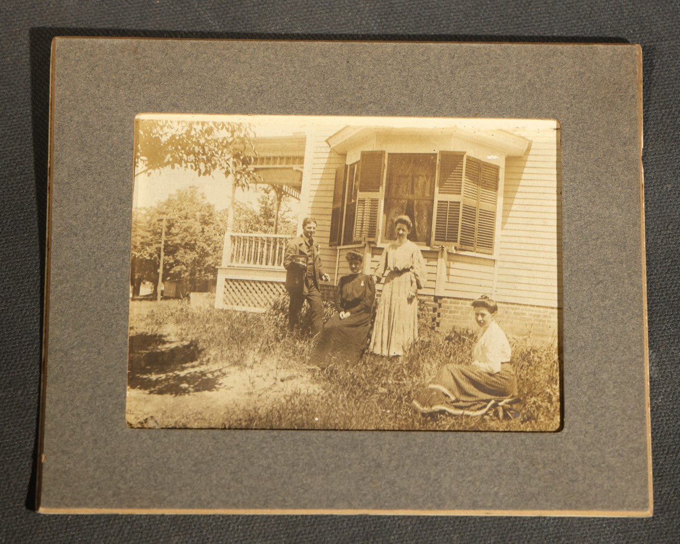 Grouping of Nine Antique Photographs, Domestic and Outdoor Scenes Including Horse-Drawn Sleigh, Children with Dogs, Women at Home, and Horse in Snow