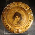 Lot 056 - Antique Burrow's Malvern Waters "Malvernia" Advertising Ceramic Ashtray with Portrait of "Molly," The Associated Potteries Co., Hancock & Corfield Ltd., Mitcham London, 5-1/8" W
