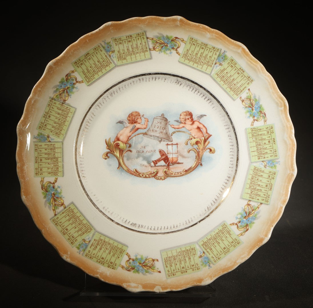 Antique Porcelain 1910 Calendar Plate with Cherubs, New Year Bell, and Hourglass Motif, Note Chip to Lower Center Rim