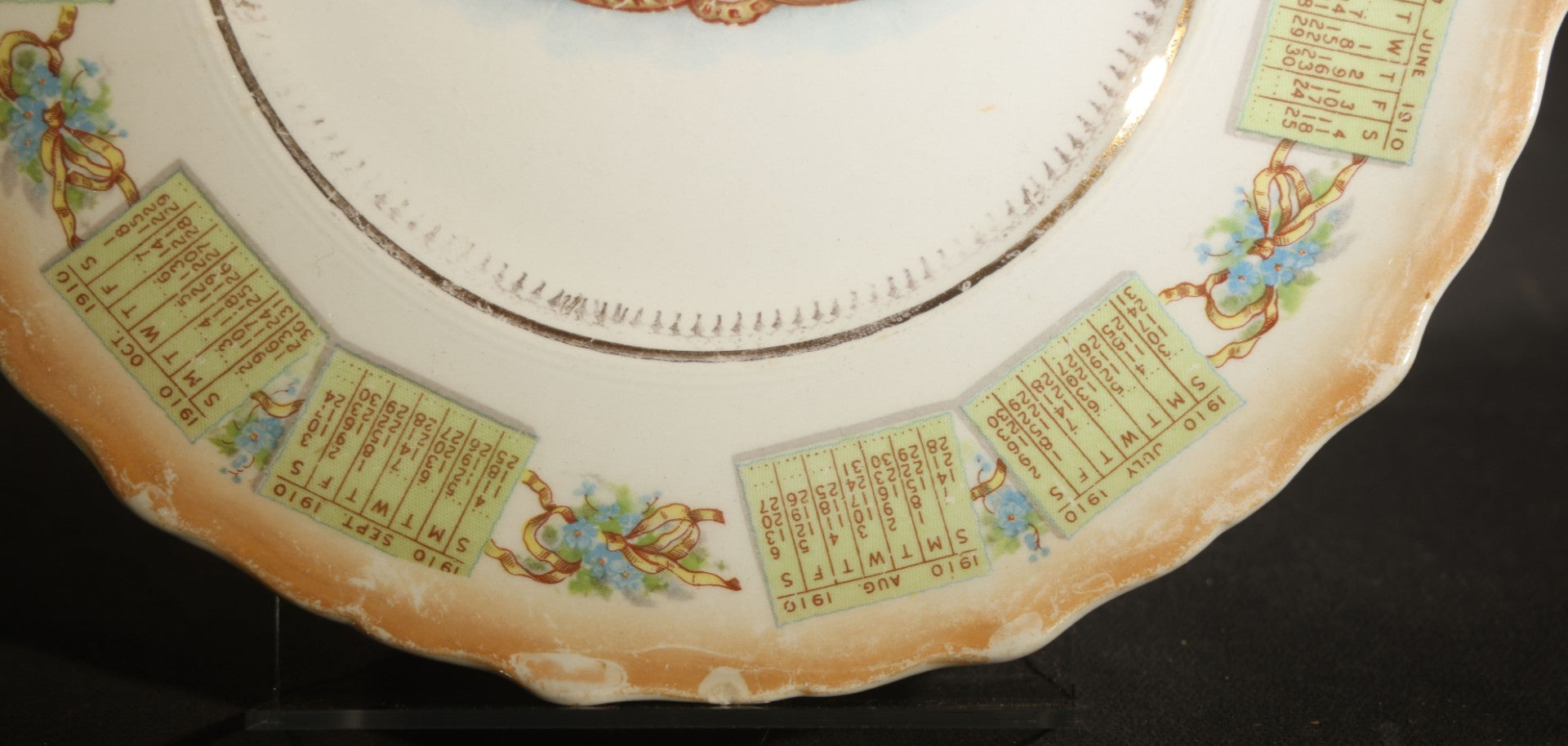 Antique Porcelain 1910 Calendar Plate with Cherubs, New Year Bell, and Hourglass Motif, Note Chip to Lower Center Rim