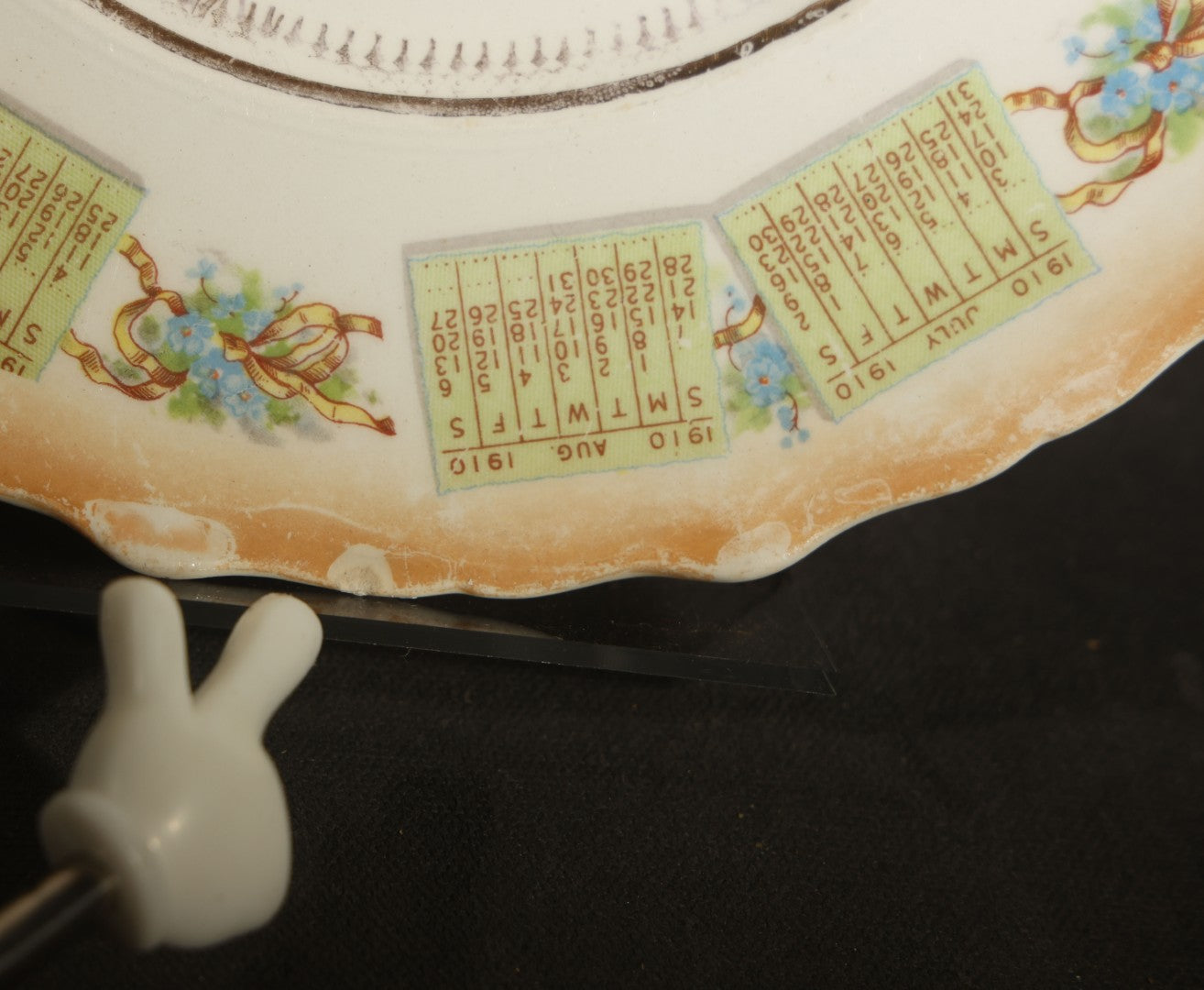 Antique Porcelain 1910 Calendar Plate with Cherubs, New Year Bell, and Hourglass Motif, Note Chip to Lower Center Rim
