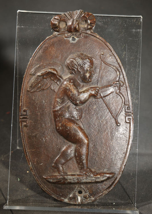 Antique Cast Iron Oval Wall Plaque of Cupid with Bow and Arrow, Shell and Crown Crest, Note Loss to Top of Bow