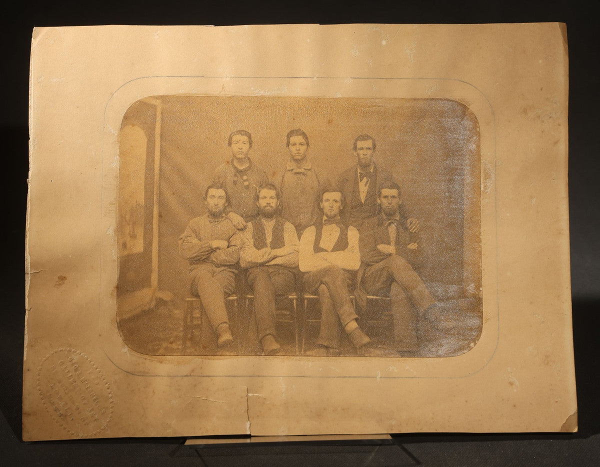 Trio of Antique Board-Mounted Photographs of Group Portraits, Including Seven Men Photographed by Geo. E. Mitchell's Gallery of Art, Lowell, Massachusetts, a Large Military or Militia Group with Rifles, and Ten Men on Building Steps
