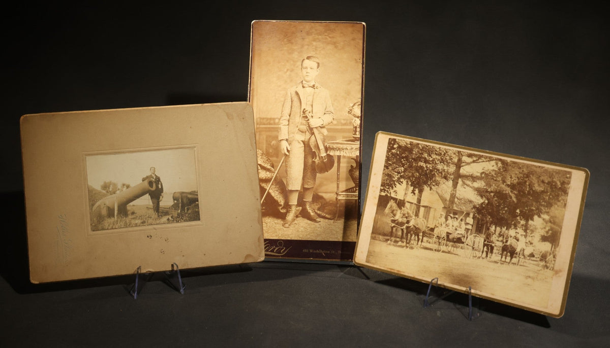 Trio of Antique Board-Mounted Photographs Including a Cabinet Card of a Boy with Violin, by Hardy, Boston, a Horse-Drawn Carriage Party by J. P. Haseltine, Lancaster, New Hampshire, and a Man Posed with Cannons, by Hollis Studio, Boston
