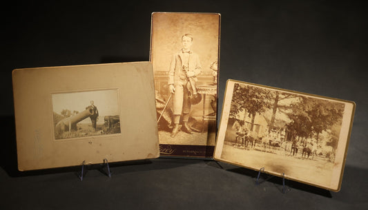 Trio of Antique Board-Mounted Photographs Including a Cabinet Card of a Boy with Violin, by Hardy, Boston, a Horse-Drawn Carriage Party by J. P. Haseltine, Lancaster, New Hampshire, and a Man Posed with Cannons, by Hollis Studio, Boston